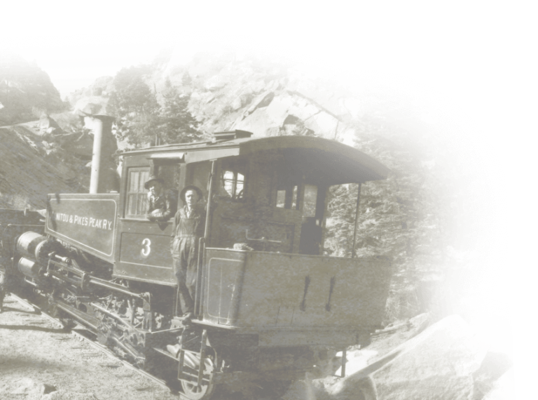 A grainy black and white image of men on a train.