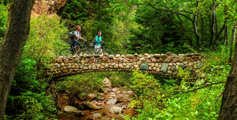 A couple biking over a bridge in Colorado Springs