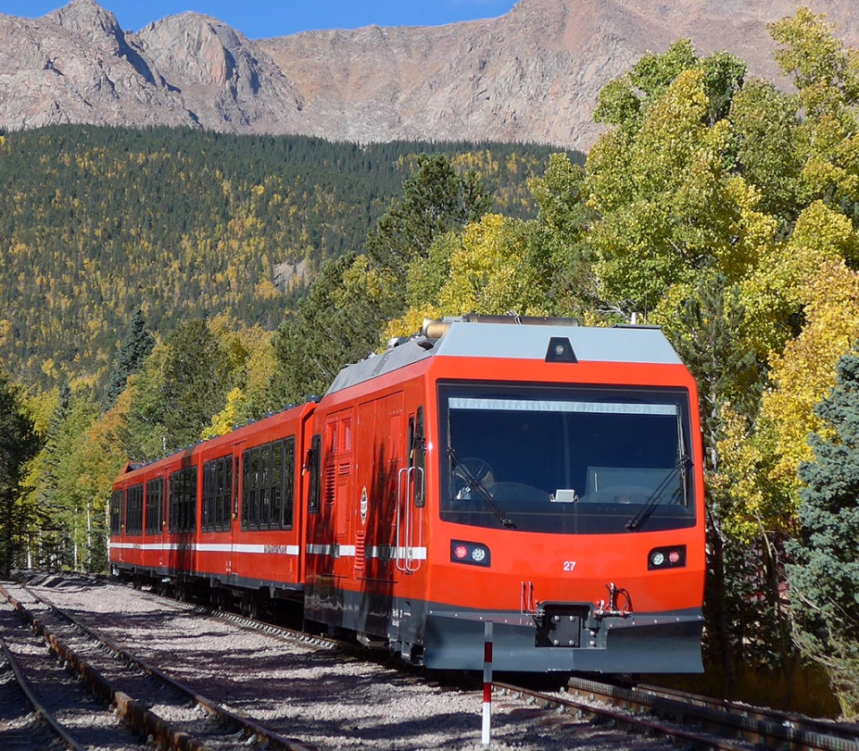 Train on tracks with mountain views