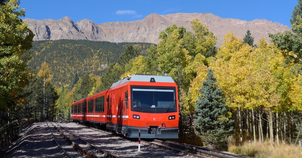 Train on tracks with mountain views