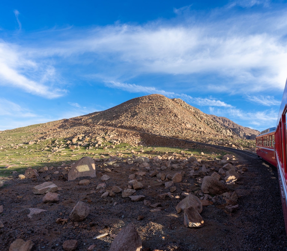 Blue skies and green hills from train passenger view