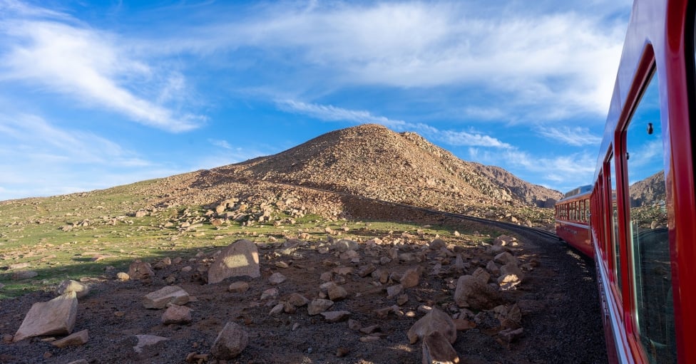 Blue skies and green hills from train passenger view