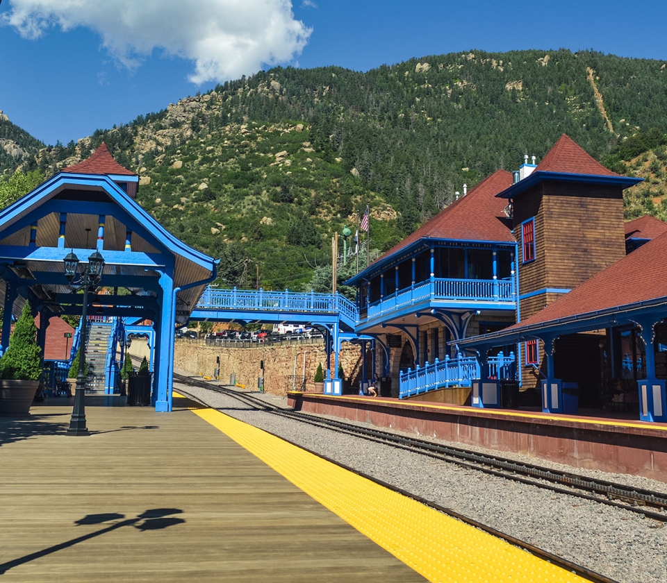 Blue building with red trim on summer day