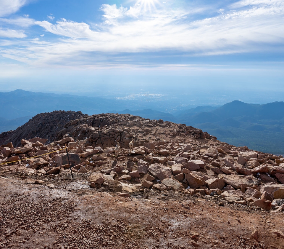 Top of mountain during sunny day with blue skies