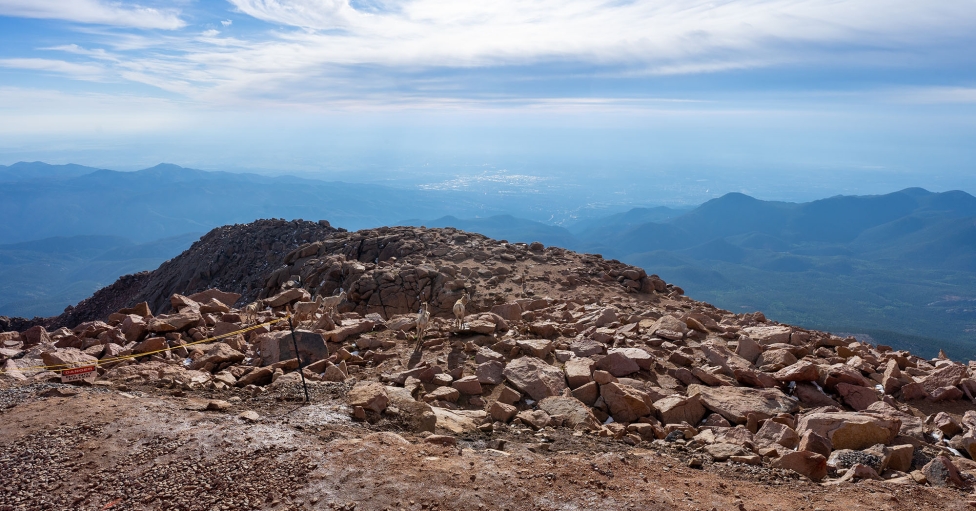Top of mountain during sunny day with blue skies