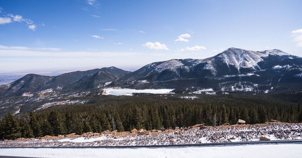 A Snowy Landscape With Trees And Mountains