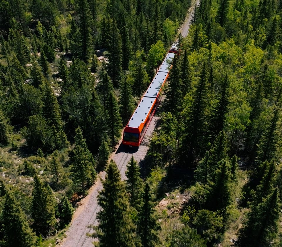 A Train On A Track Surrounded By Trees