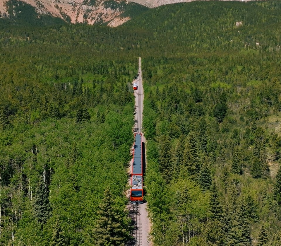 A Red Train In The Middle Of A Forest